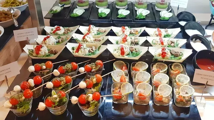 Buffet de evento corporativo con vasitos y brochetas